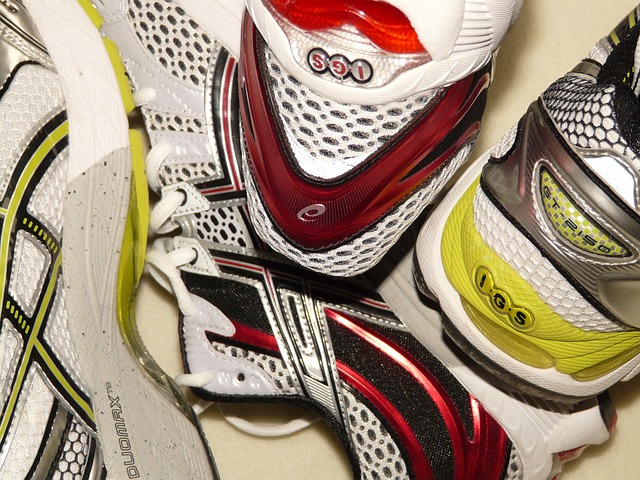 Two pairs of running shoes are jumbled together